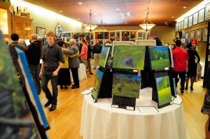 Students, parents, and guests look at the work on display for the Art show